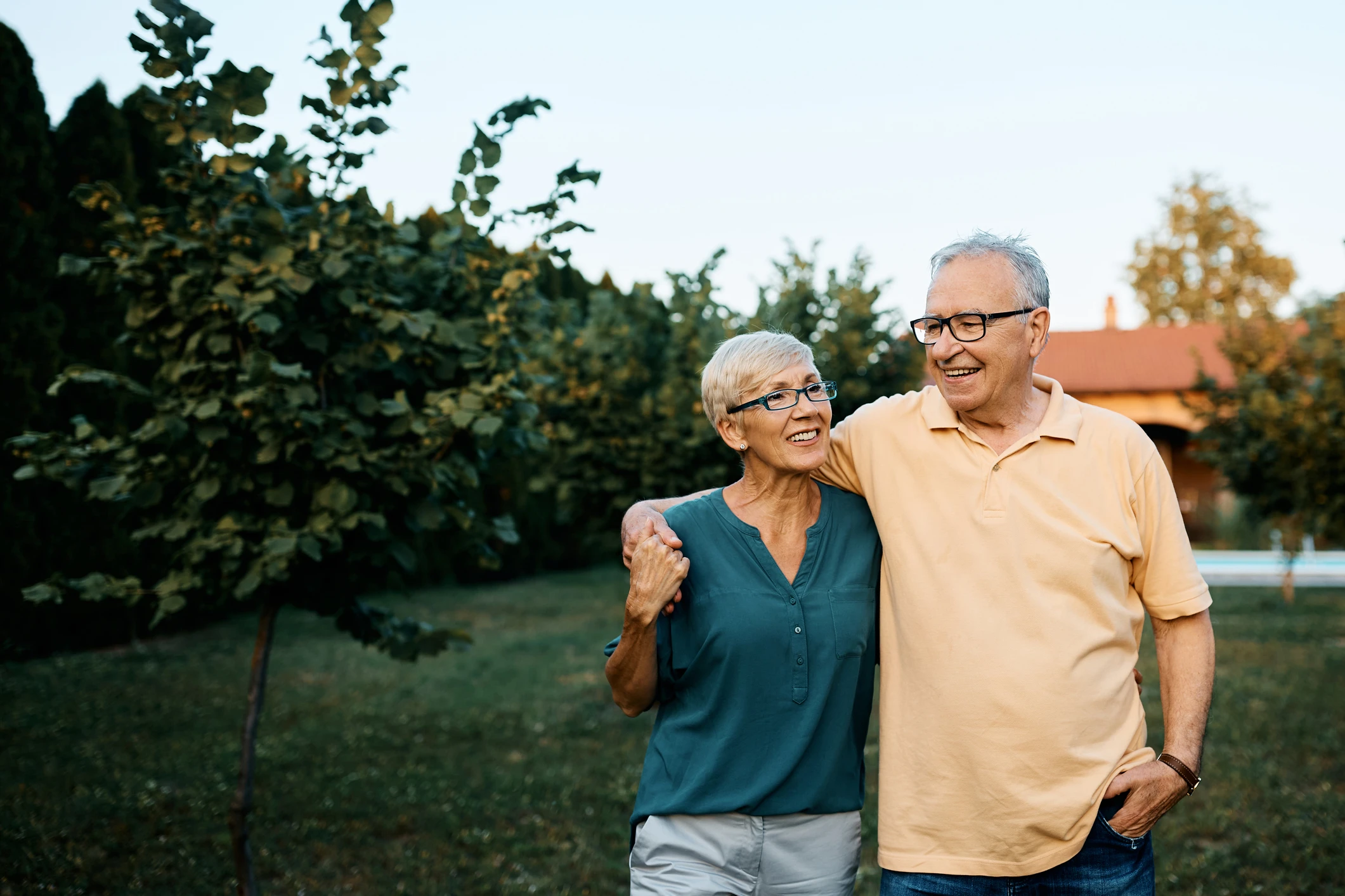 older caucasian couple walking outside