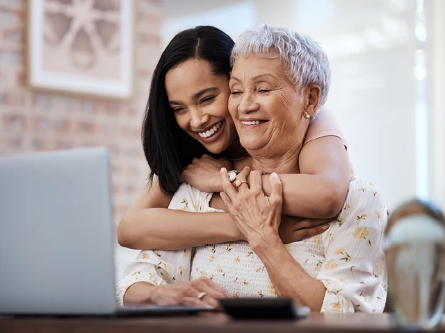 mom and adult daughter at computer