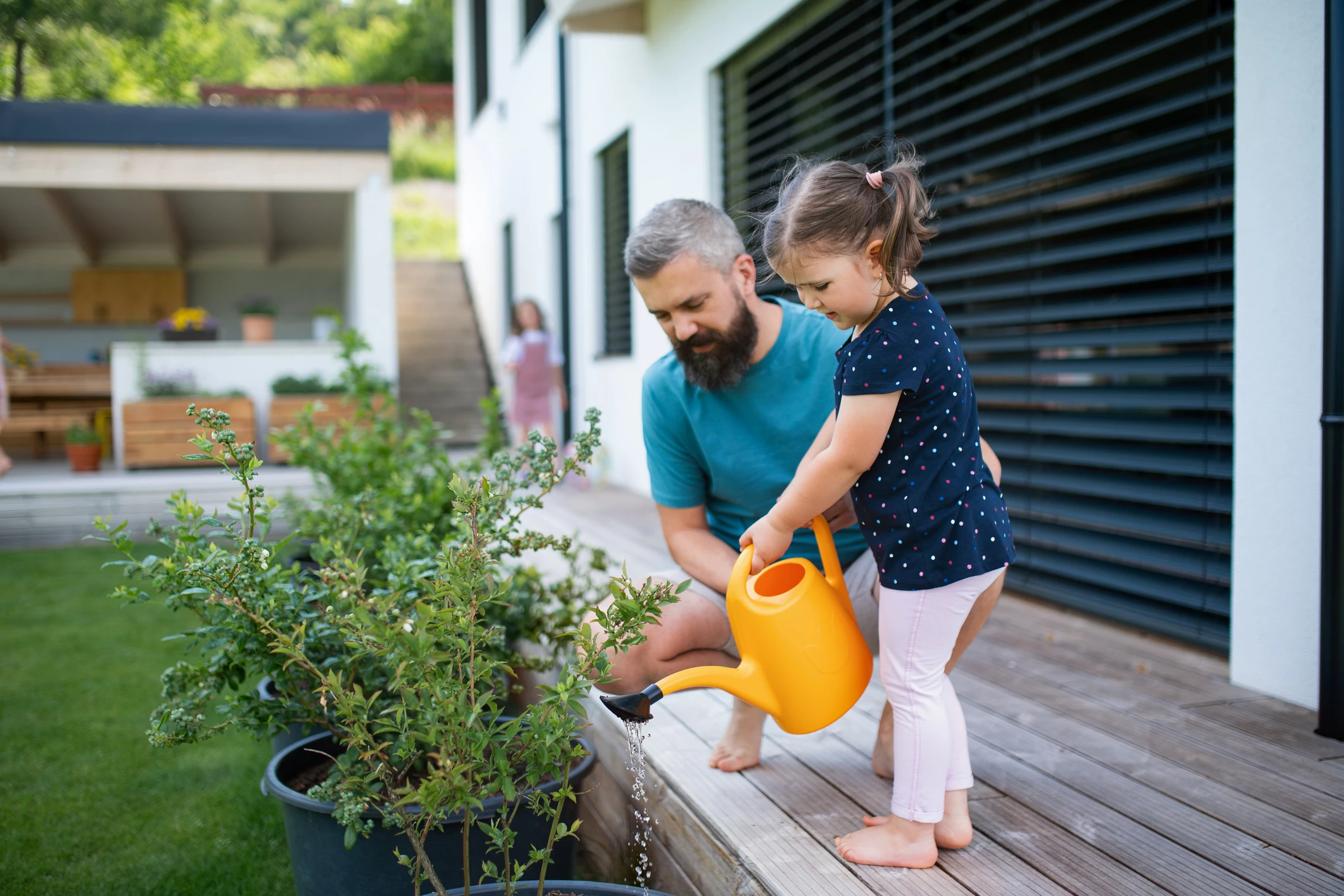 caucasian father and daughter gardening