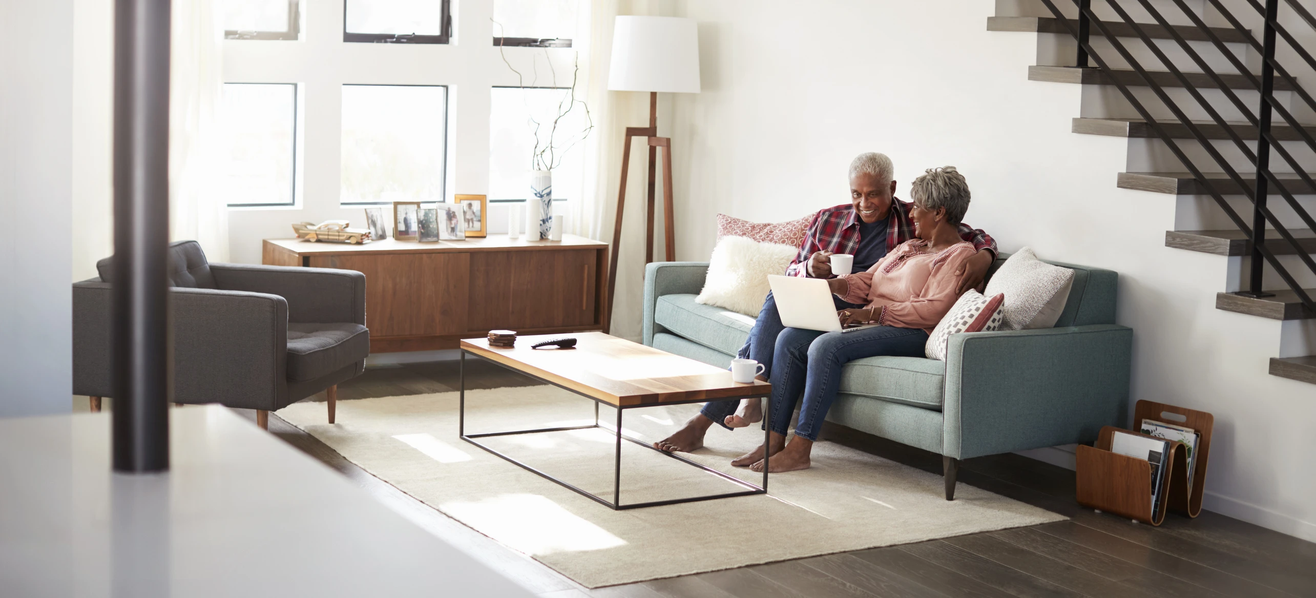 older african american couple sitting on couch at home