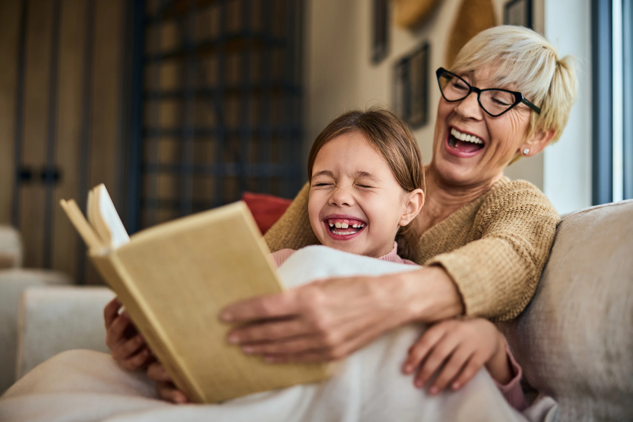 caucasian grandma and granddaughter reading