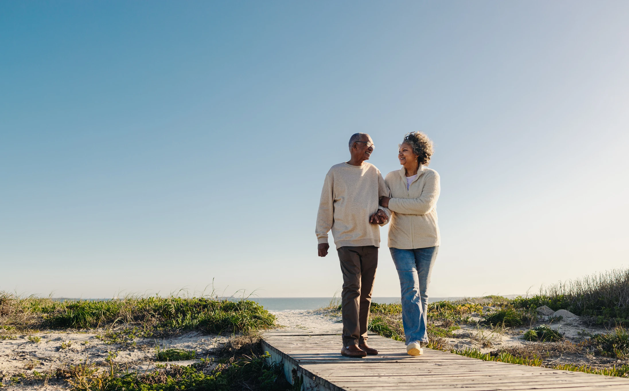 african american couple walking the beach